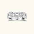 Wide sterling silver ring with three rows of brilliant moissanite stones in geometric pavé setting on white background