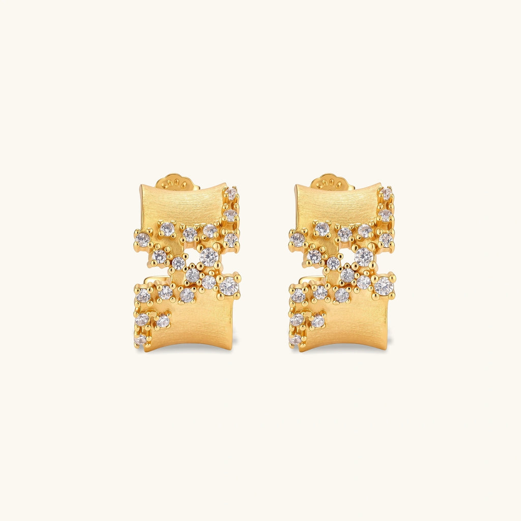 Pair of 18K gold-plated 925 sterling silver C-hoop earrings with brushed finish and scattered cubic zirconia clusters.
