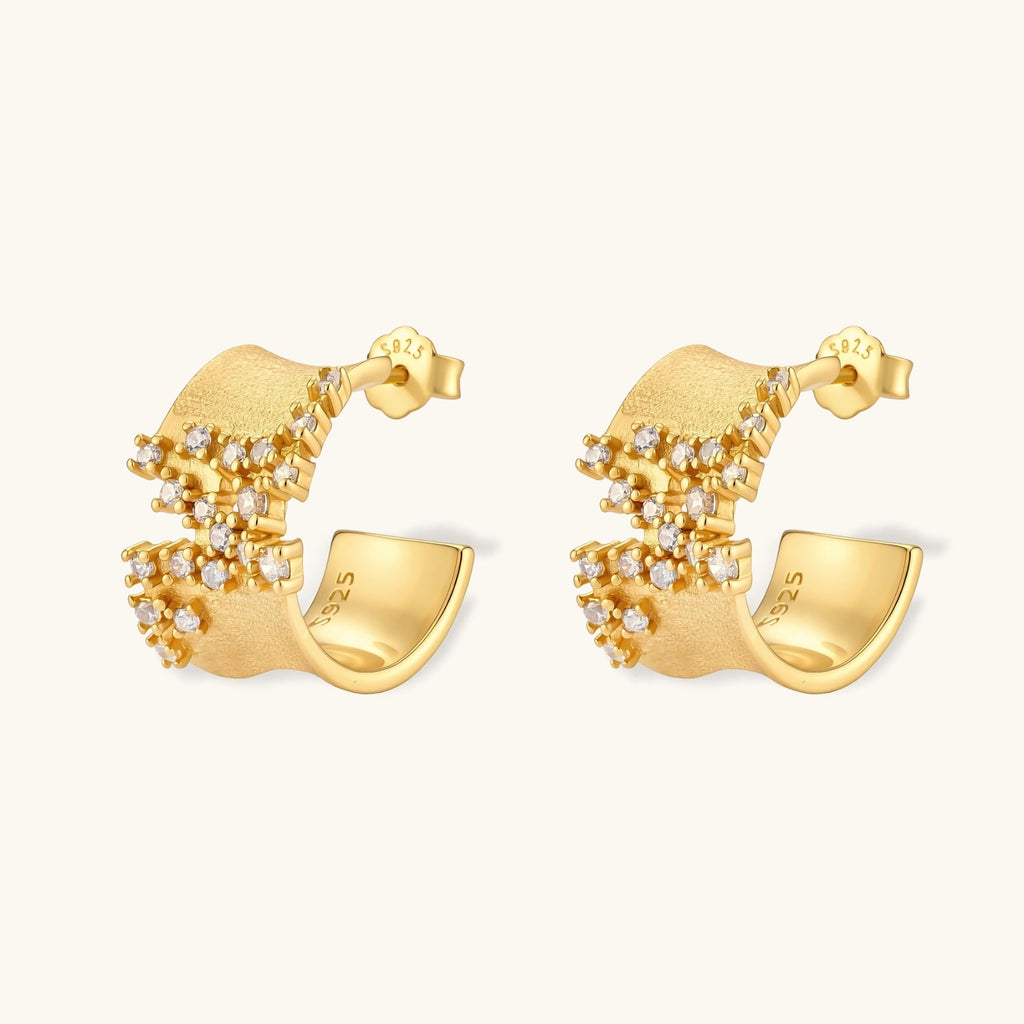Pair of 18K gold-plated 925 sterling silver C-hoop earrings with brushed finish and scattered cubic zirconia clusters.